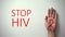 Stop HIV inscription, hand with red ribbon, awareness and prevention campaign