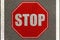 Stop icon in red painted on road lane , text is stop traffic movement