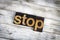 Stop Letterpress Word on Wooden Background