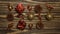 Stop motion animation. Christmas tree toys with a snake move on a wooden background. Pine cone, bell, ball, gift