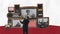 Stop motion, animation. Conceptual design. Businessman standing in front of many retro TV sets with people talking