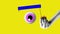 Stop motion, animation. female hand holding giant eyeball over yellow color background. Creative artwork. Concept of