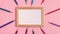 Stop motion animation mockup of wooden frame and pencils around it on pink background. Flat lay top view. Education template back