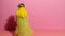 Stop motion animation, moving wooden doll made of felt. Female doll with long yellow hair, with a purple flower wreath