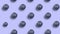 Stop Motion Animation. Pattern of round ripe blueberries pressed in the form of a random button on a blue background