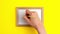 Stop motion animation of pencil in the hand on wooden frame in the centre with white copy space on yellow background Saint Patrick
