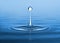 Stop motion of droplet on water surface creating wave in the sea