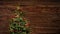 Stop motion of red festive decorations self-finishing a christmas tree