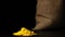 Stop motion: turmeric powder heap growing near a sac