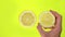 Stop Motion video Cut lemon in a female hand. Lemon halves on vivid yellow background. Vitamin C. Vegetarian food. Lemon freshness