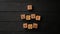 Stop-motion wooden cubes with the phrase I Love You on a black background - a wooden table. Words of love are made