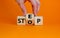 Stop or next step symbol. Businessman turns cubes and changes the word `stop` to `step`. Beautiful orange background, copy spa