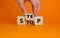 Stop or next step symbol. Businessman turns cubes and changes the word `stop` to `step`. Beautiful orange background, copy spa