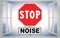 Stop Noise written on roadsign - concept with an open window