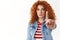 Stop please. Timid serious-looking redhead cute girl gather courage extend index finger taboo prohibition gesture