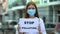 Stop pollution sign holding teenage girl in protective mask, volunteering