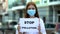 Stop pollution sign holding teenage girl in protective mask, volunteering