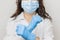 Stop SARS-CoV, SARSCoV, virus 2020 , chinese virus COVID-19. Womans hands in blue medical gloves show STOP sign to