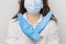 Stop SARS-CoV, SARSCoV, virus 2020 , chinese virus COVID-19. Womans hands in blue medical gloves show STOP sign to illness. Doctor