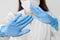 Stop SARS-CoV, SARSCoV, virus 2020 , MERS-CoV ,chinese virus COVID-19. Closeup womans hands in blue medical gloves show STOP sign