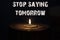 Stop saying tomorrow - white candle with dark background - in a