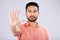 Stop, serious and portrait of an Asian man with a hand isolated on a grey studio background. Negative, no and Japanese