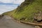 Stop Sign Alerting Traffic to Danger on Narrow Coastal Road