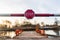 STOP sign and barrier before entering the river ferry. Late winter afternoon, snow still visible