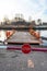 STOP sign and barrier before entering the river ferry. Late winter afternoon, snow still visible