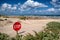 A stop sign buried in the sand