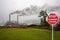 Stop sign climate change. factory emitting smoke pollution