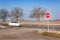 Stop Sign at Crossroads. Rural road. Exit onto the main road. Main road. Dangerous road. Traffic signs stop.