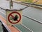 Stop sign hangs from metal chain onboard canal boat