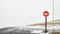 Stop sign at a mountain roads intersection during blizzard, selective focus, Colorado, USA