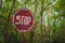 Stop sign - old rusty, frayed, scratched red road sign in radioactive zone in Pripyat city. Chornobyl exclusion zone