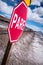 Stop sign (pare) at railway crossing in a desolate landscape