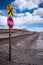 Stop sign (pare) at railway crossing in a desolate landscape