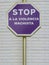 Stop sign with purple background and the message written in Spanish stop violence against women (Stop a la violencia machista