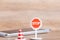 Stop sign with traffic cone over blurred smart phone on wooden floor