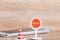 Stop sign with traffic cone over blurred smart phone on wooden floor