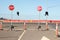 Stop signs and various warning signs warning oncoming traffic of the end of the road on a highway still under construction in