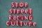 Stop Street Racing Culture, social issue slogan composed with red colored stone letters on the sand