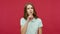 Stop talking! Dissatisfied strict young brunette woman in polo t-shirt making qu