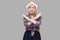 Stop. There is no way. Portrait of serious modern stylish mature woman in casual style with hat standing with X sign and looking