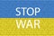 Stop War - lettering with Ukraine flag on the background of a brick wall. International protest, Stop the war against