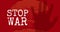 Stop war text by hand over explosion on red background