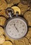 Stop watch on heaped of gold coins