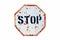 Stop written in bold letters in a rusty and grungy white and red old road traffic sign