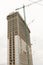 The stopped construction of a high-rise building. Unfinished floors of a multi-storey building without external walls. Exterior of