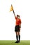 Stopping game. Young woman, soccer referee raising flag up meaning ball is out-of-play and game need restart against